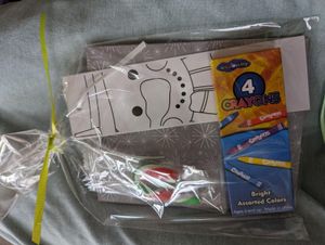 A 'play it forward' book kit from Humanity in Practice. Contains a book, a bookmark, crayons, and a cuddly dog to snuggle.